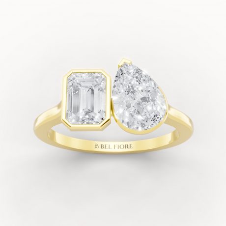 Emerald cut diamond paired with a pear shaped diamond- Yellow Gold